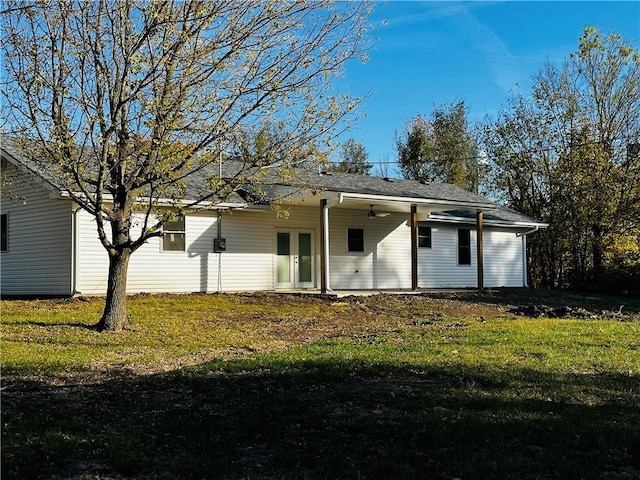 rear view of property with a yard