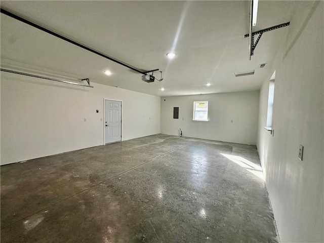 garage featuring a garage door opener and electric panel