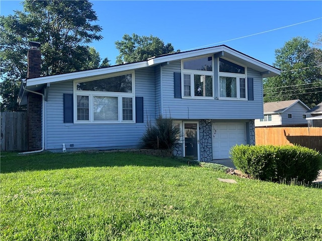 view of front of home featuring a garage and a front yard