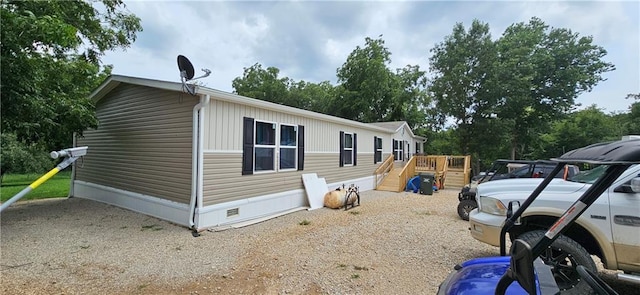 view of side of home featuring a wooden deck