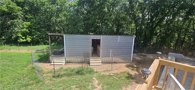 view of outbuilding featuring a yard