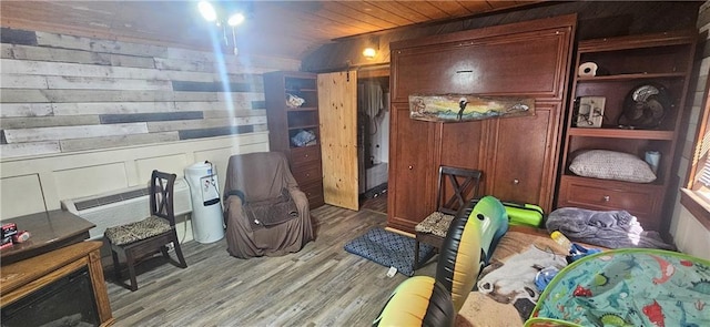 interior space featuring light wood-type flooring and wood walls