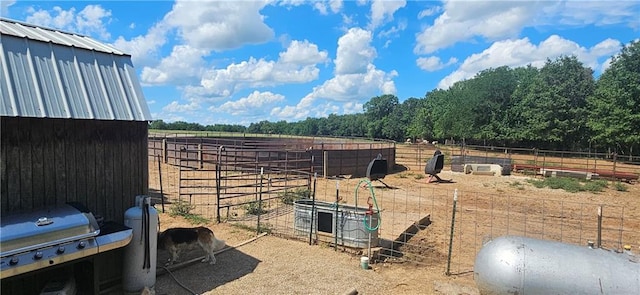 view of yard with a rural view and an outdoor structure