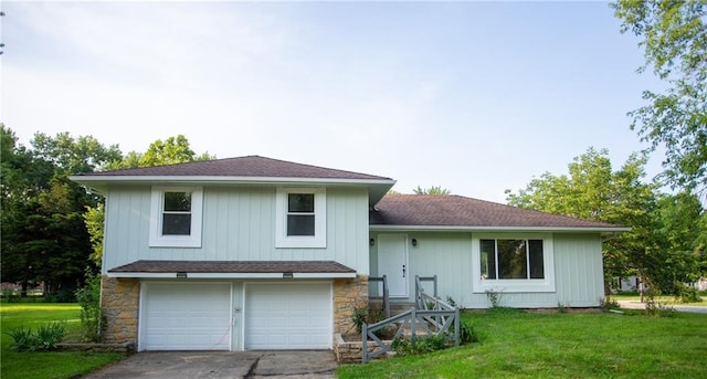 rear view of house with a garage and a lawn