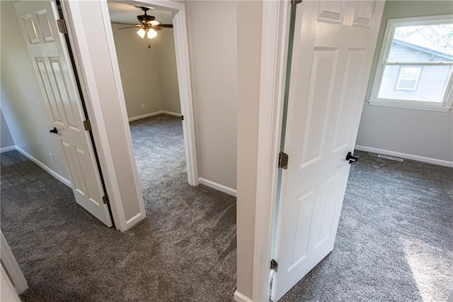 hall featuring carpet floors and baseboards