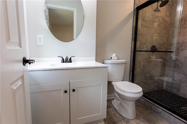 bathroom featuring a stall shower, vanity, and toilet