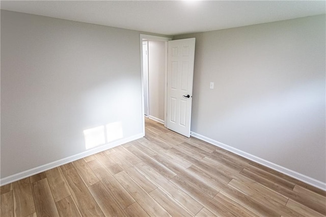 unfurnished room featuring light wood-style floors and baseboards