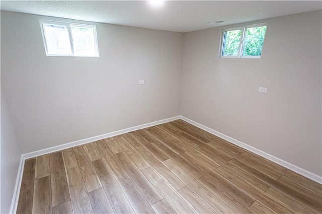 interior space with light wood finished floors, a healthy amount of sunlight, and baseboards