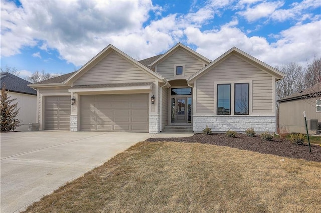 view of front of property featuring a garage and a front lawn