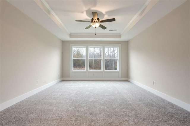 unfurnished room with carpet, a raised ceiling, ceiling fan, and crown molding