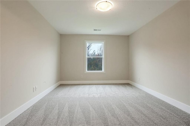 unfurnished room featuring light carpet