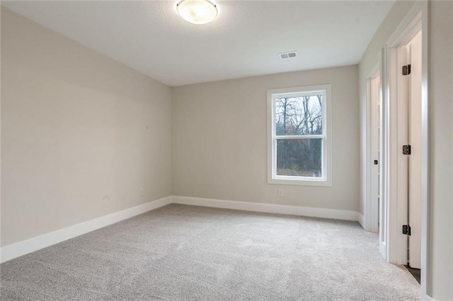 unfurnished room featuring light colored carpet