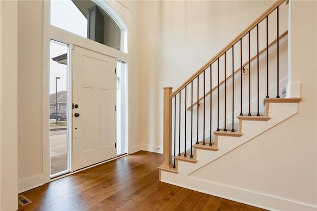 entryway with hardwood / wood-style floors and a healthy amount of sunlight