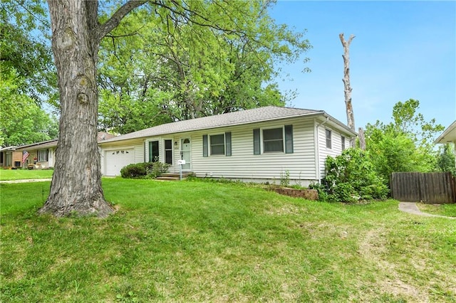 single story home with a garage and a front lawn