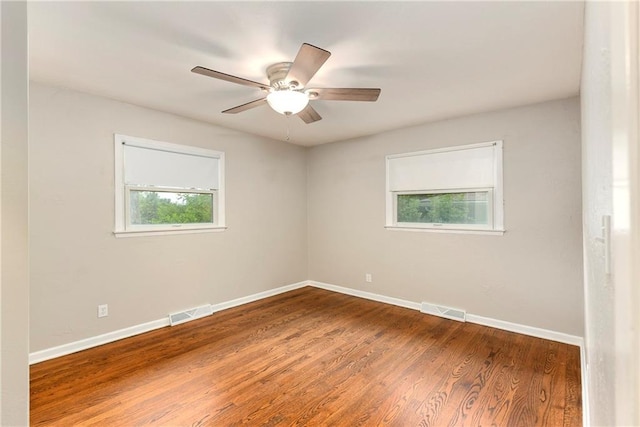 empty room featuring wood-type flooring and ceiling fan