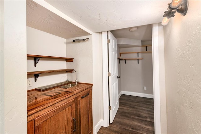 hall featuring dark hardwood / wood-style floors and sink