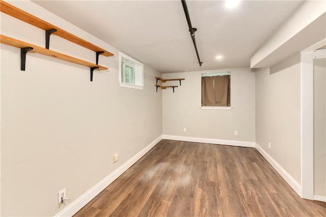 basement with hardwood / wood-style flooring