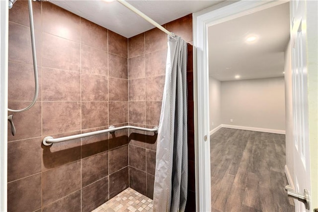 bathroom with walk in shower and hardwood / wood-style flooring