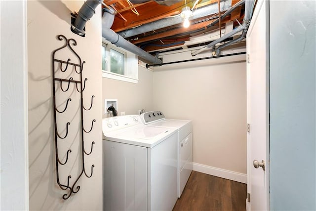 laundry area featuring dark wood-type flooring and independent washer and dryer