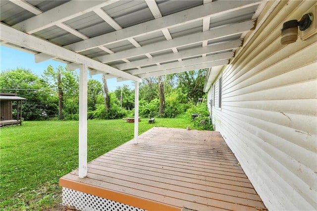 wooden terrace featuring a yard