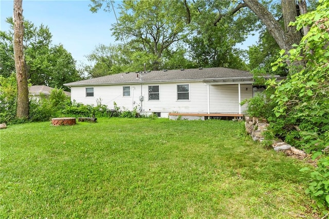 rear view of property with a yard