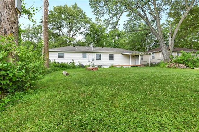 back of house featuring a yard