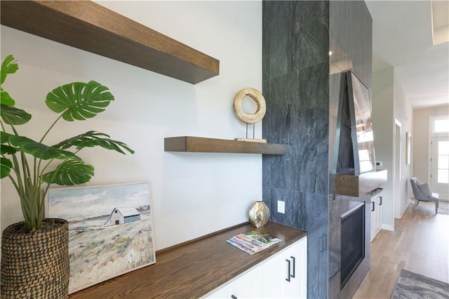 kitchen featuring light hardwood / wood-style flooring and white cabinets