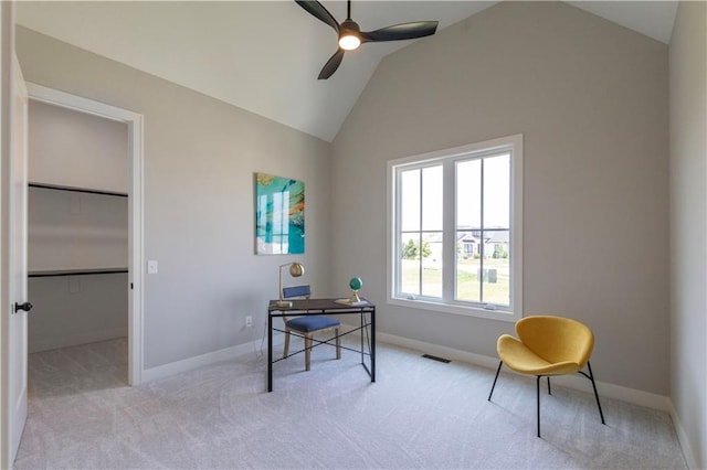 home office with ceiling fan, light colored carpet, and vaulted ceiling