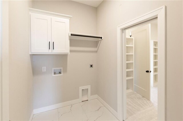 washroom featuring hookup for a washing machine, cabinets, and hookup for an electric dryer