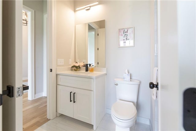 bathroom featuring hardwood / wood-style floors, vanity, and toilet