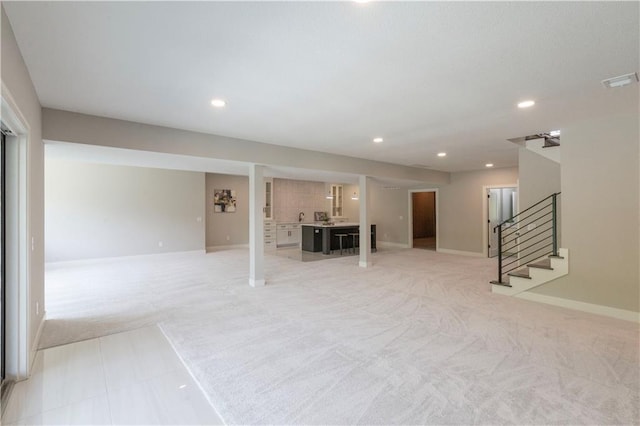 unfurnished living room with light carpet