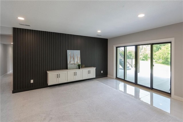 unfurnished living room with light carpet