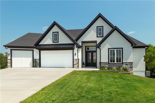 view of front of property with french doors, a front lawn, and a garage