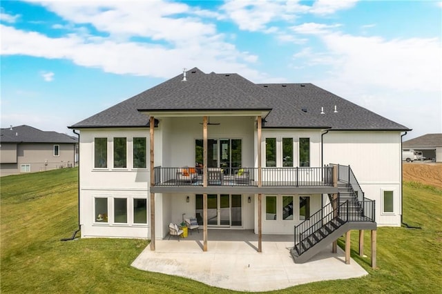 rear view of property with a lawn, a patio area, and a deck