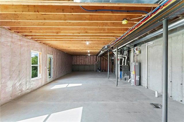 basement with electric water heater and heating unit