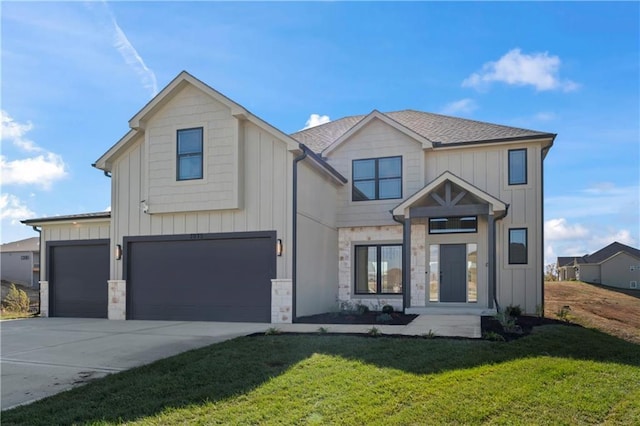 7075 NW Magnus Ct, Parkville, MO 64152 - view of front of property featuring concrete driveway, a front lawn, an attached garage, stone siding, and board and batten siding