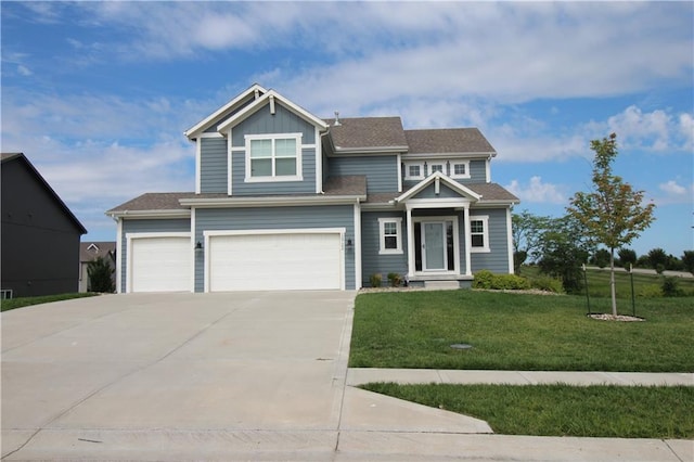 view of front of property featuring a garage and a front lawn