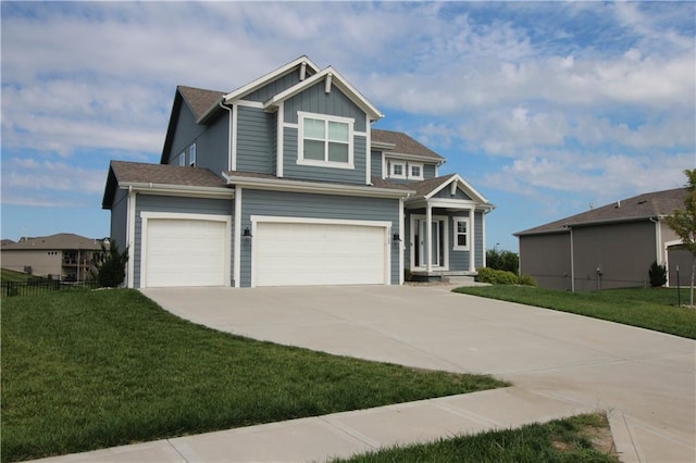 view of front of home with a garage and a front lawn