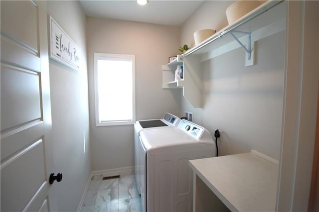 clothes washing area with washer and clothes dryer