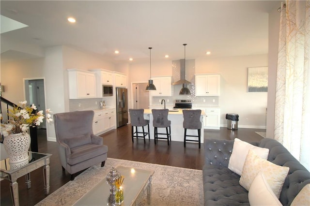 living room with dark wood-type flooring and sink