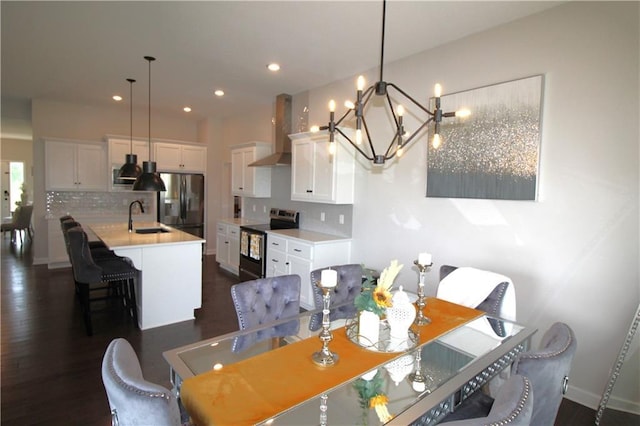 dining room featuring dark hardwood / wood-style floors, a chandelier, and sink