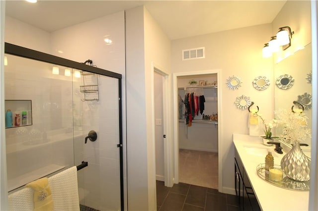 bathroom with vanity, tile patterned floors, and a shower with shower door