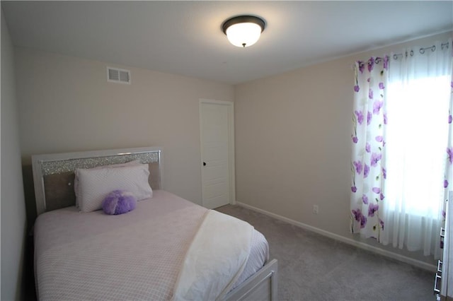 carpeted bedroom featuring multiple windows