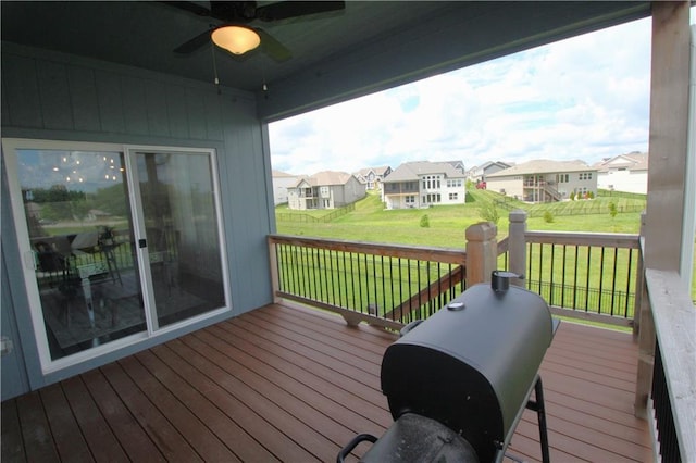 deck featuring ceiling fan and a yard