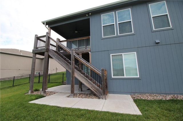 rear view of property with a lawn and a patio