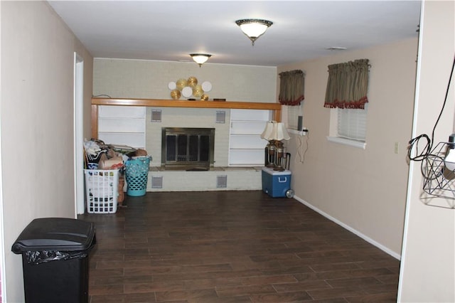 living room with dark hardwood / wood-style floors and a fireplace