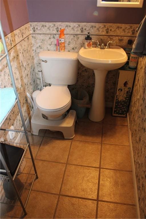 bathroom featuring toilet and tile patterned floors