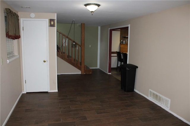 corridor with dark hardwood / wood-style flooring