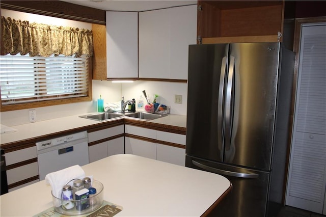 kitchen featuring stainless steel fridge, sink, white cabinetry, and white dishwasher