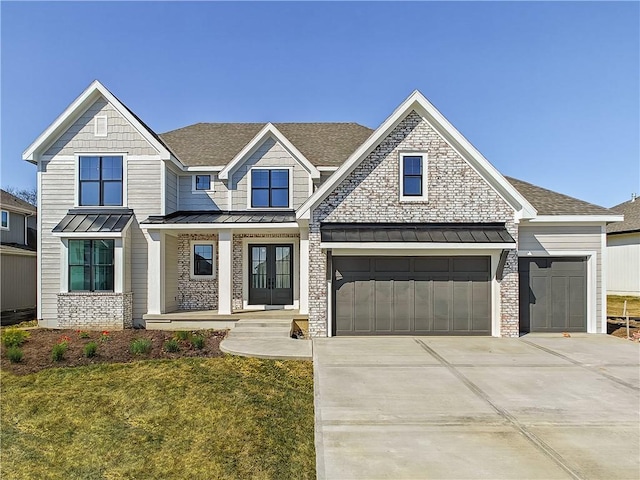 17212 Nieman Rd, Overland Park, KS 66221 - view of front of house with a standing seam roof, french doors, roof with shingles, driveway, and a front lawn